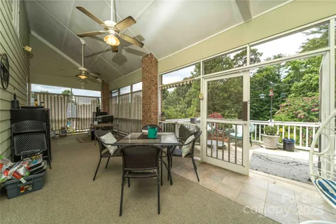 a view of a porch with furniture and a yard