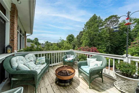 a view of a chair and tables in the balcony