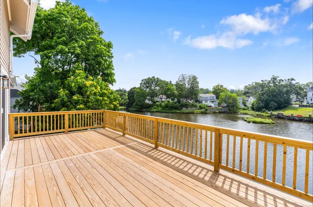 a view of balcony with wooden floor and fence