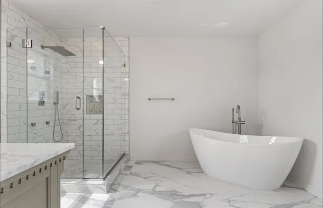 a bathroom with a bathtub and shower