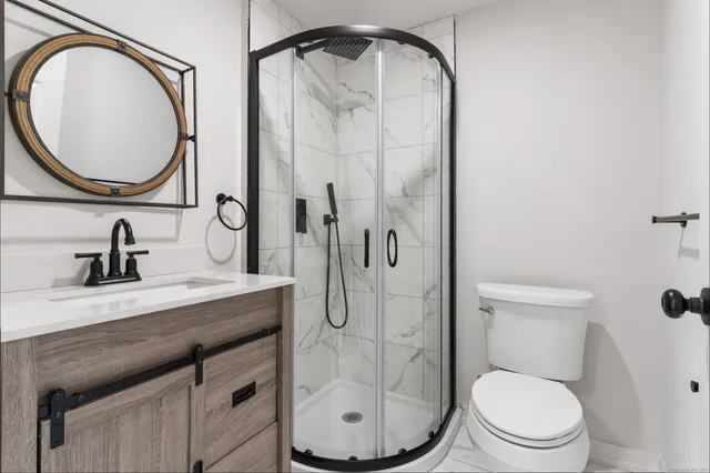 a bathroom with a sink a toilet and a mirror