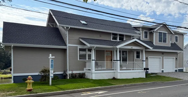 a view of brick house with a yard