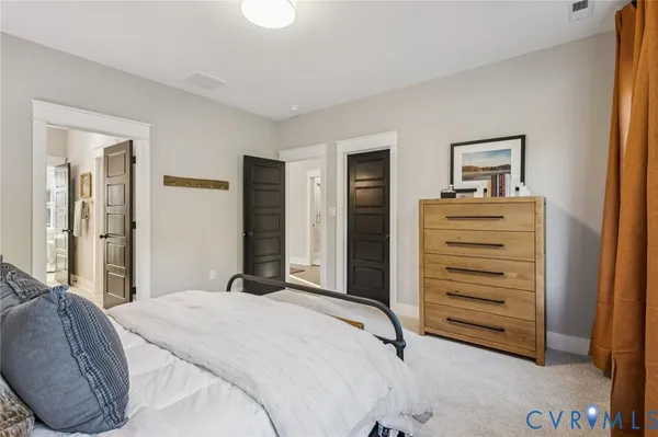 a bedroom with a bed and a dresser