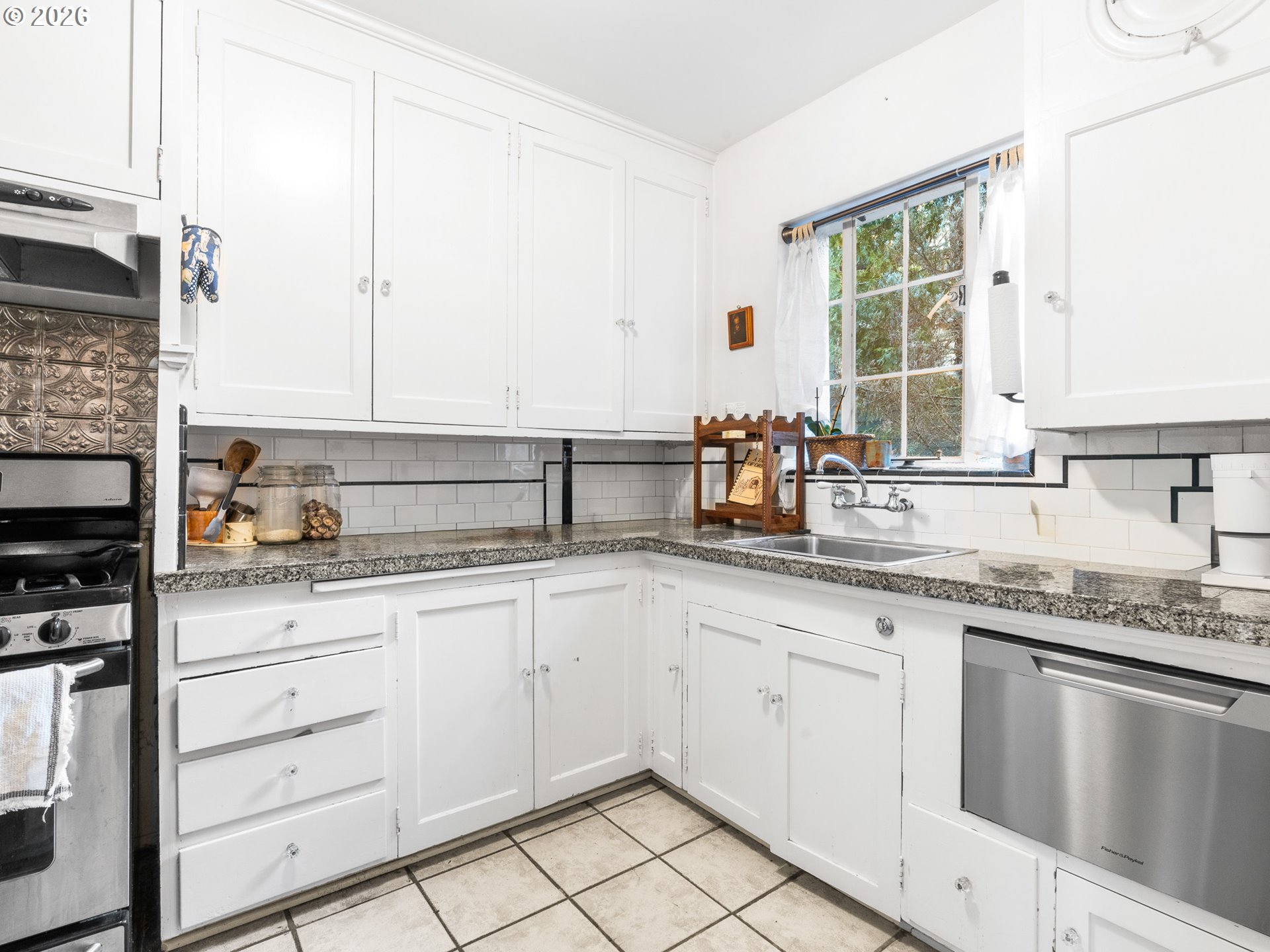2325 Northeast Flanders Street, Unit 6 Portland, OR 97232 - Photo 9 of 20 a kitchen with granite countertop white cabinets and white appliances