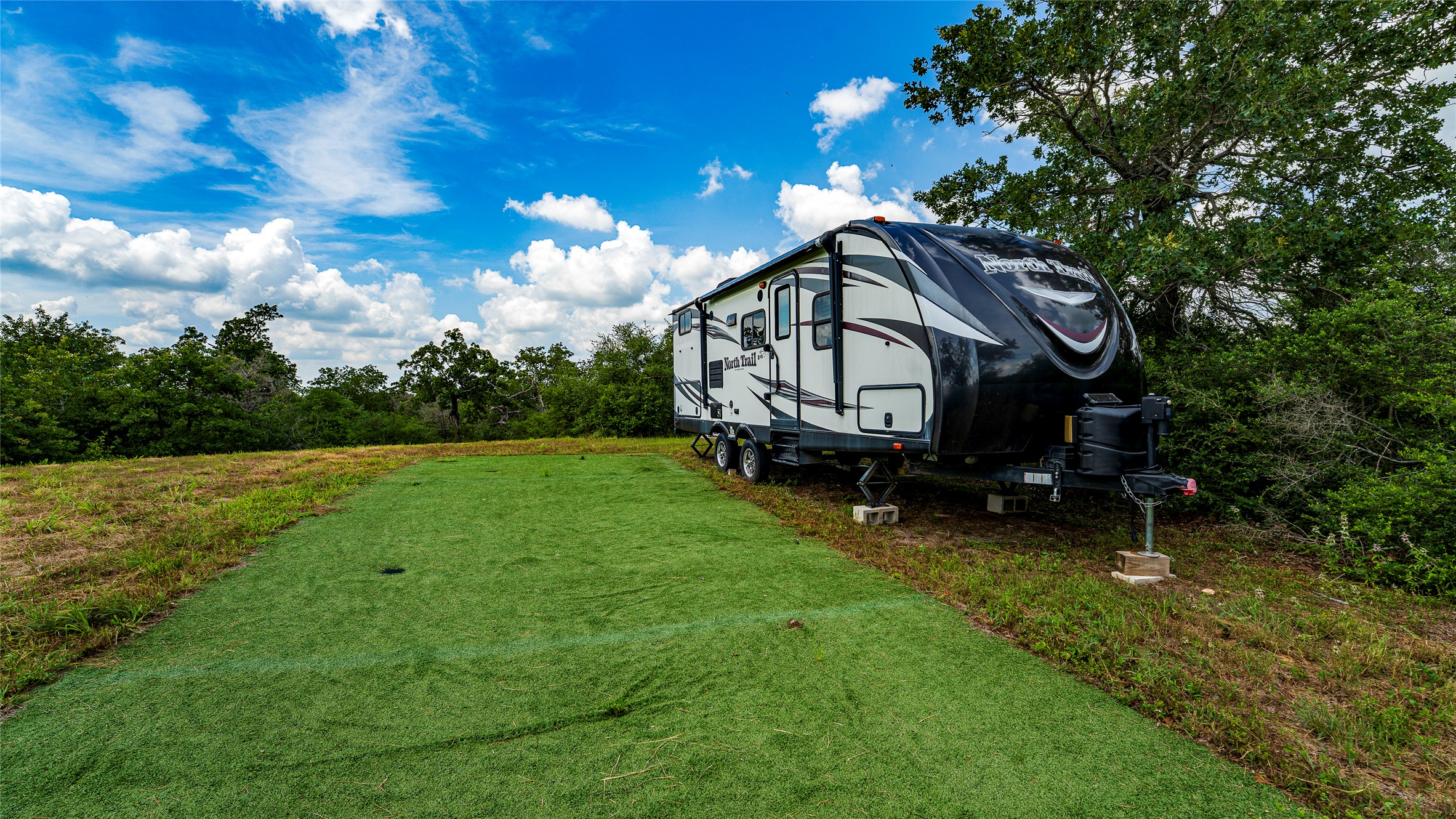 1470 22 Hills Road Gause, TX 77857 - Photo 15 of 35 A spacious yard boasts a dedicated green space for leisure, complementing the mobile living options.