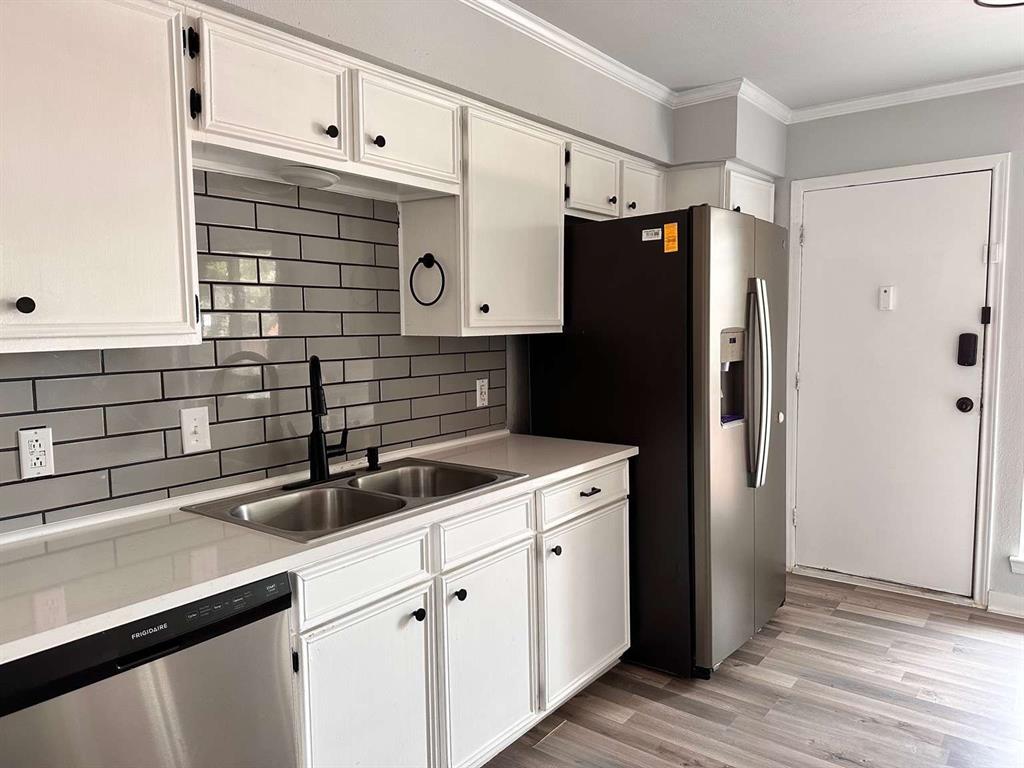 10526 Stone Canyon Road, Unit 201 Dallas, TX 75230 - Photo 1 of 21 a kitchen with a sink and refrigerator