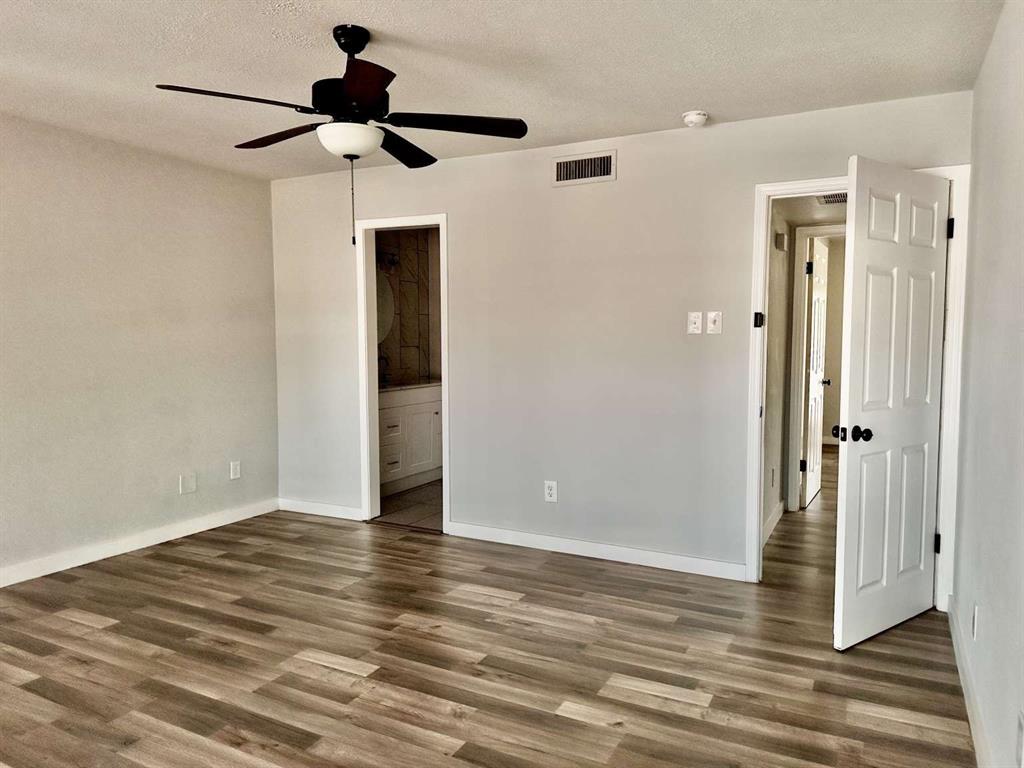 10526 Stone Canyon Road, Unit 201 Dallas, TX 75230 - Photo 11 of 21 a view of an empty room and wooden floor