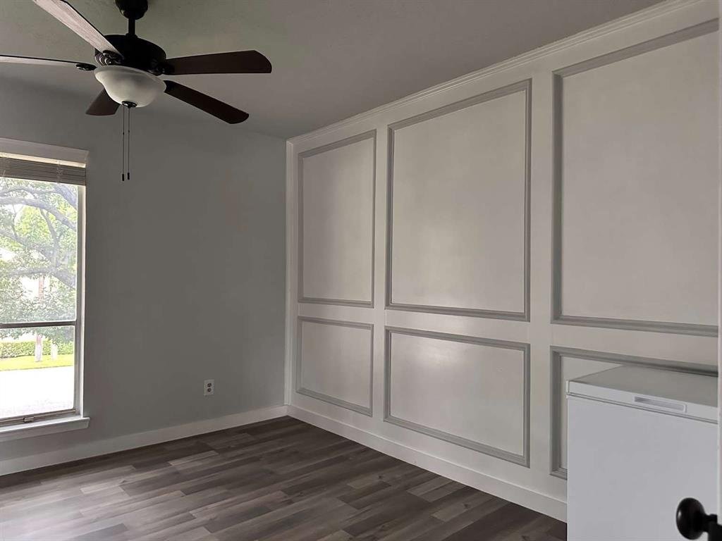 10526 Stone Canyon Road, Unit 201 Dallas, TX 75230 - Photo 18 of 21 a view of an empty room with wooden floor and a window