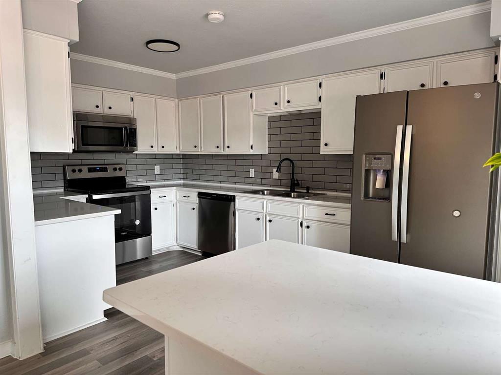 10526 Stone Canyon Road, Unit 201 Dallas, TX 75230 - Photo 2 of 21 a kitchen with stainless steel appliances a refrigerator stove microwave and sink