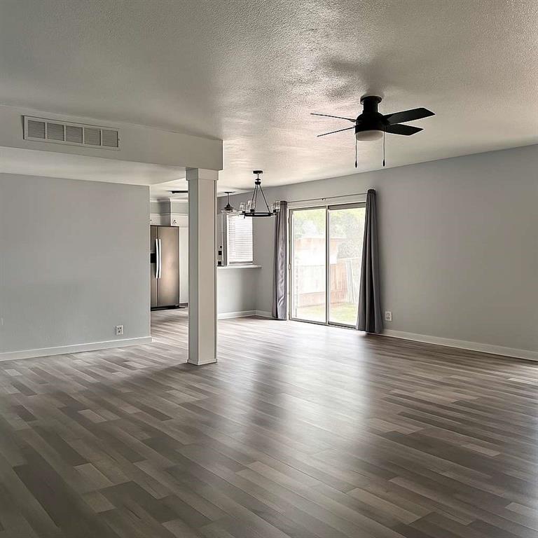 10526 Stone Canyon Road, Unit 201 Dallas, TX 75230 - Photo 5 of 21 a view of a kitchen with wooden floor and a ceiling fan