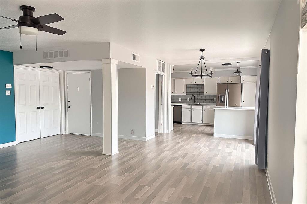 10526 Stone Canyon Road, Unit 201 Dallas, TX 75230 - Photo 6 of 21 a view of a kitchen with refrigerator and wooden floor