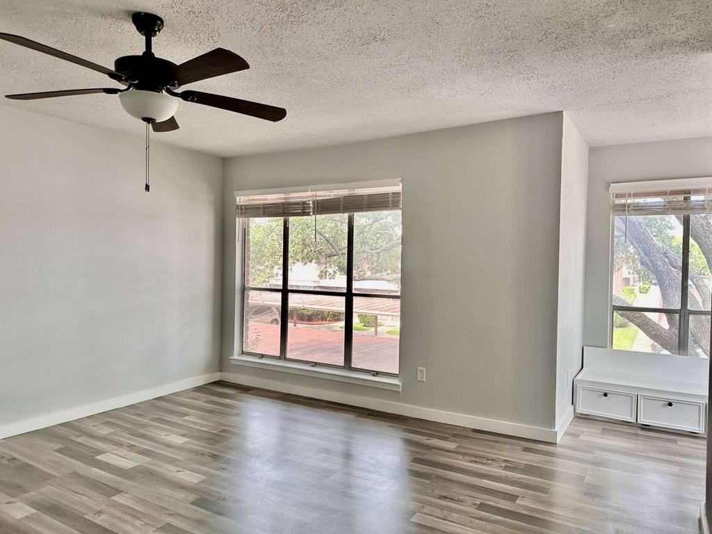 10526 Stone Canyon Road, Unit 201 Dallas, TX 75230 - Photo 9 of 21 wooden floor in an empty room with a window