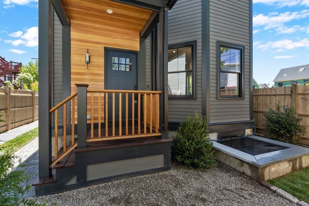 2 Adrian Street, Unit FRONT Somerville, MA 02143 - Photo 12 of 17 a view of a house with a small deck and wooden floor
