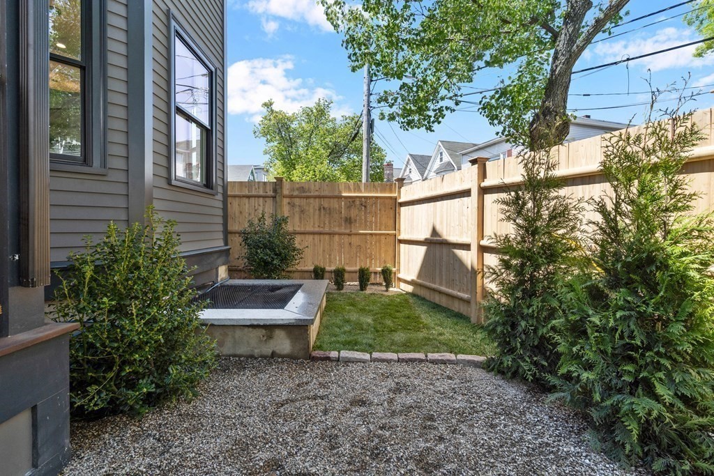 2 Adrian Street, Unit FRONT Somerville, MA 02143 - Photo 15 of 17 a view of a bench in the backyard