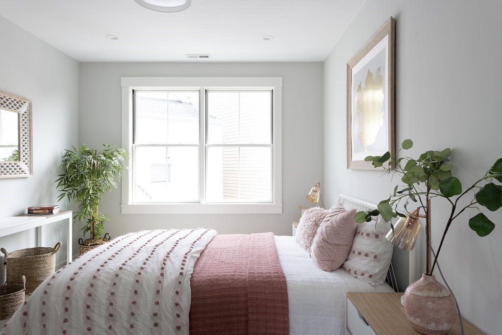 2 Adrian Street, Unit FRONT Somerville, MA 02143 - Photo 7 of 17 a bedroom with a bed and a window