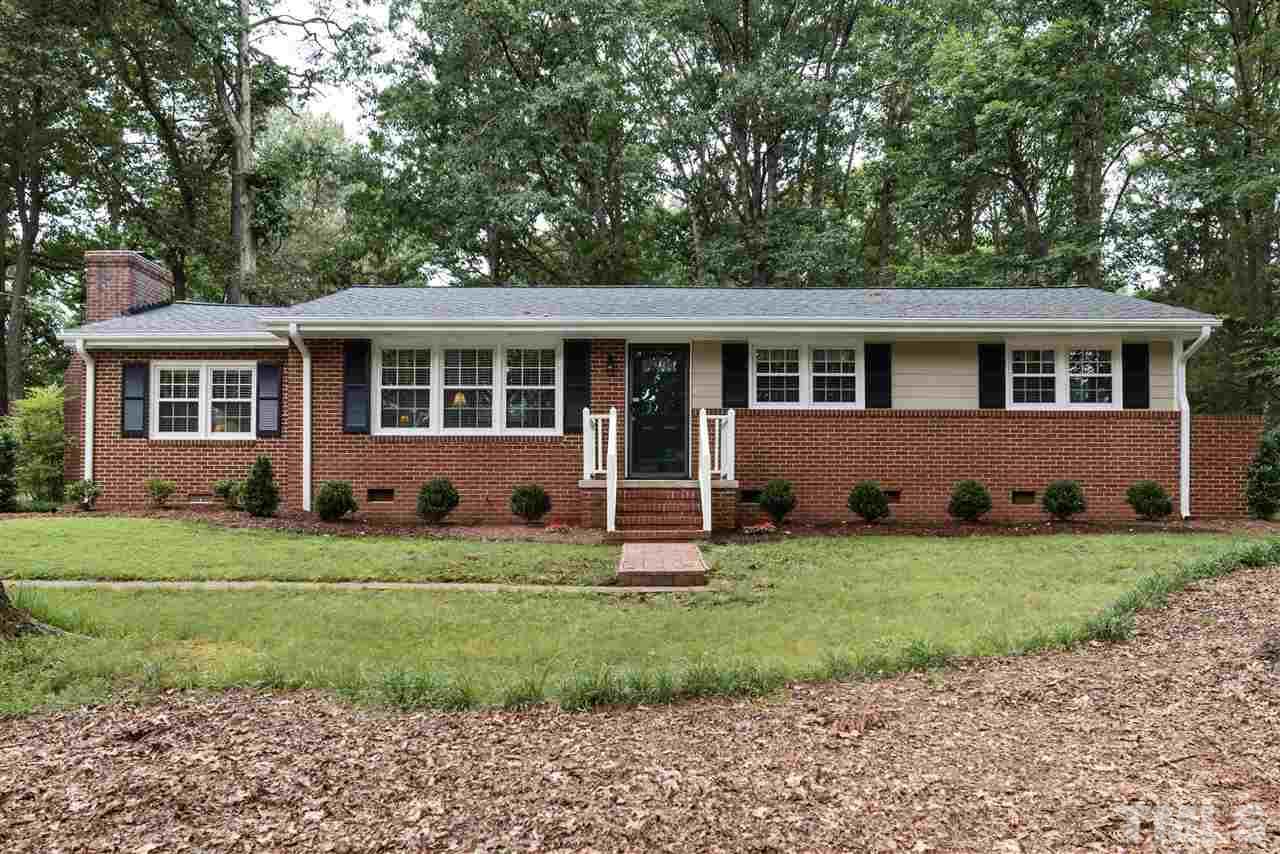 6405 Johnsdale Road Raleigh, NC 27615 - Photo 1 of 25 a house that has a big yard large trees and plants