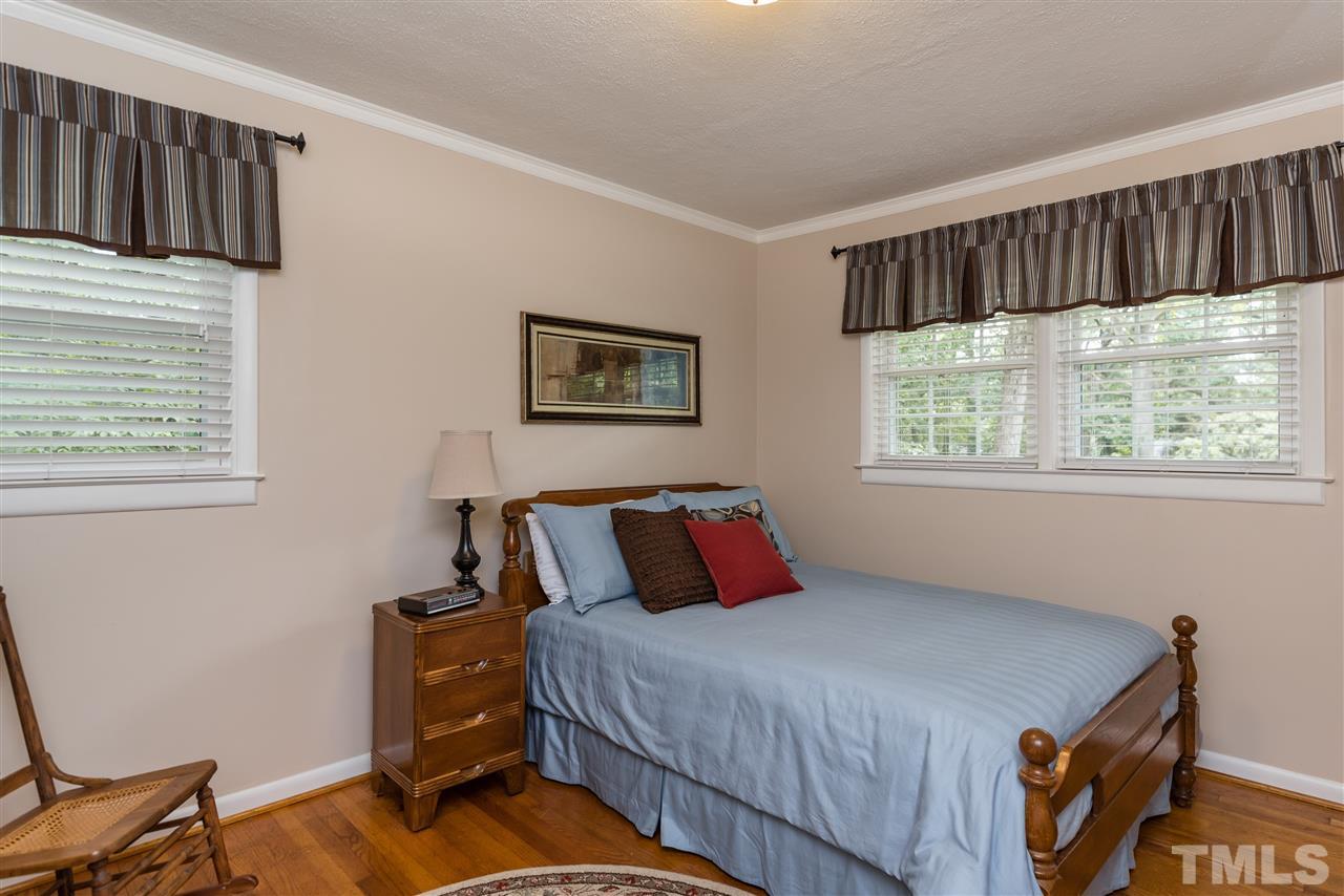 6405 Johnsdale Road Raleigh, NC 27615 - Photo 15 of 25 a bedroom with a bed and a window