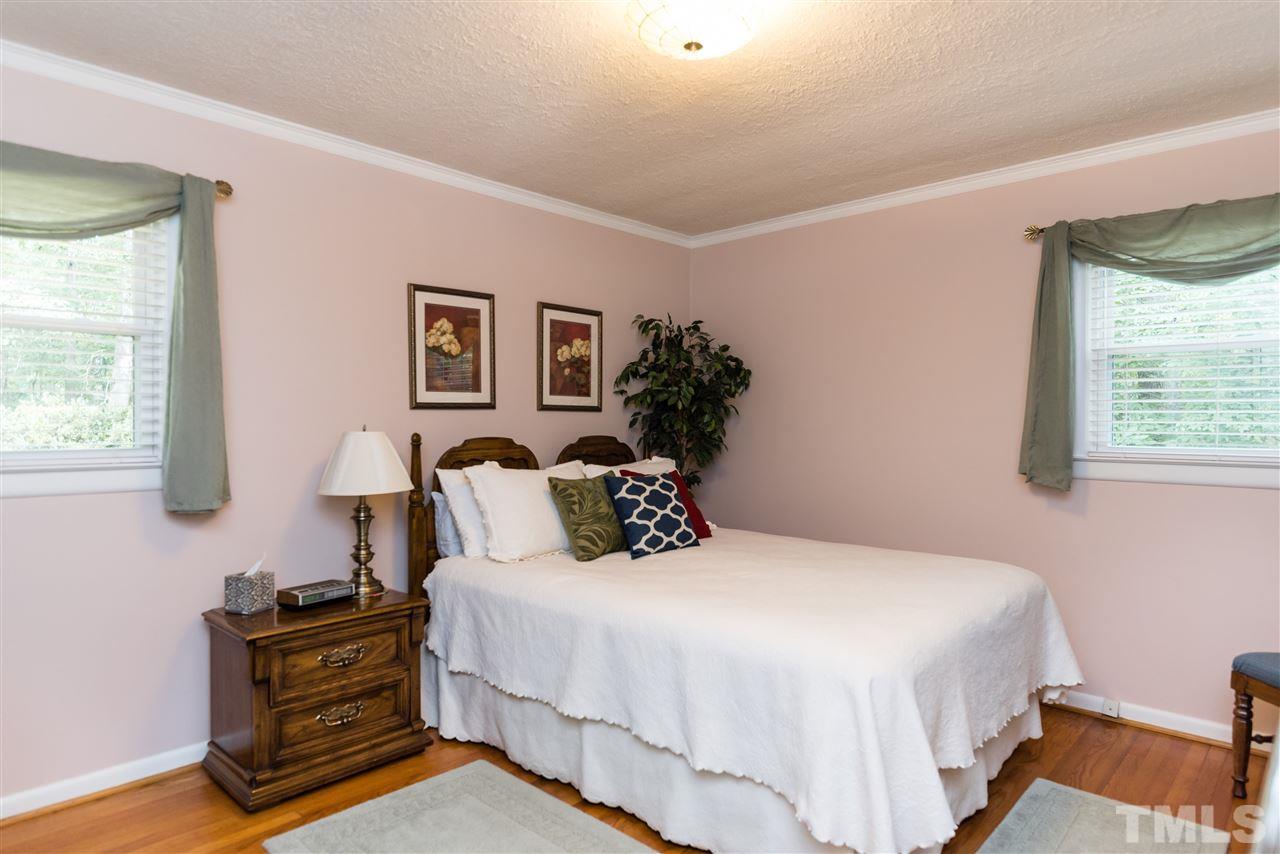 6405 Johnsdale Road Raleigh, NC 27615 - Photo 16 of 25 a bedroom with a bed and a night stand