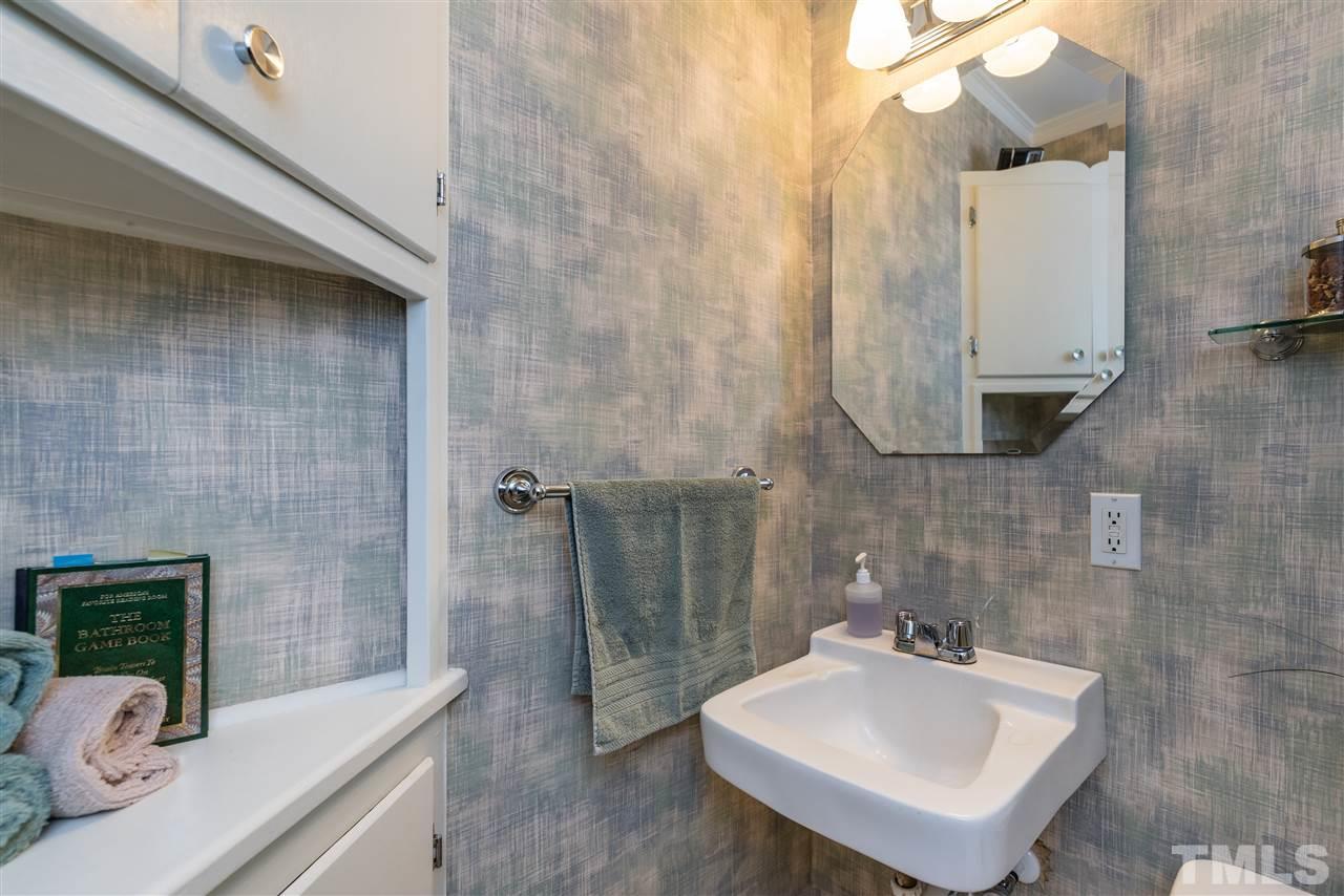 6405 Johnsdale Road Raleigh, NC 27615 - Photo 17 of 25 a bathroom with a sink a mirror and shower