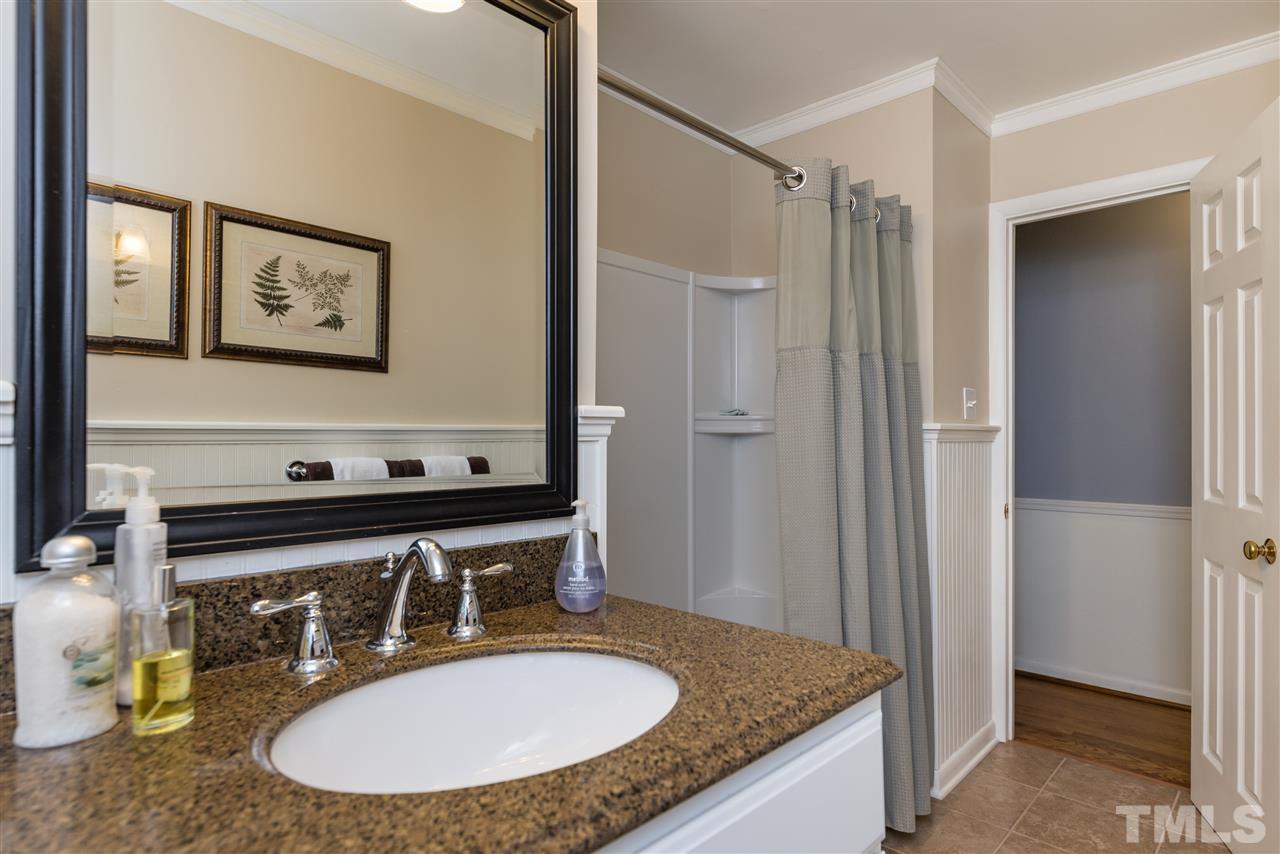 6405 Johnsdale Road Raleigh, NC 27615 - Photo 18 of 25 a bathroom with a granite countertop sink and a mirror