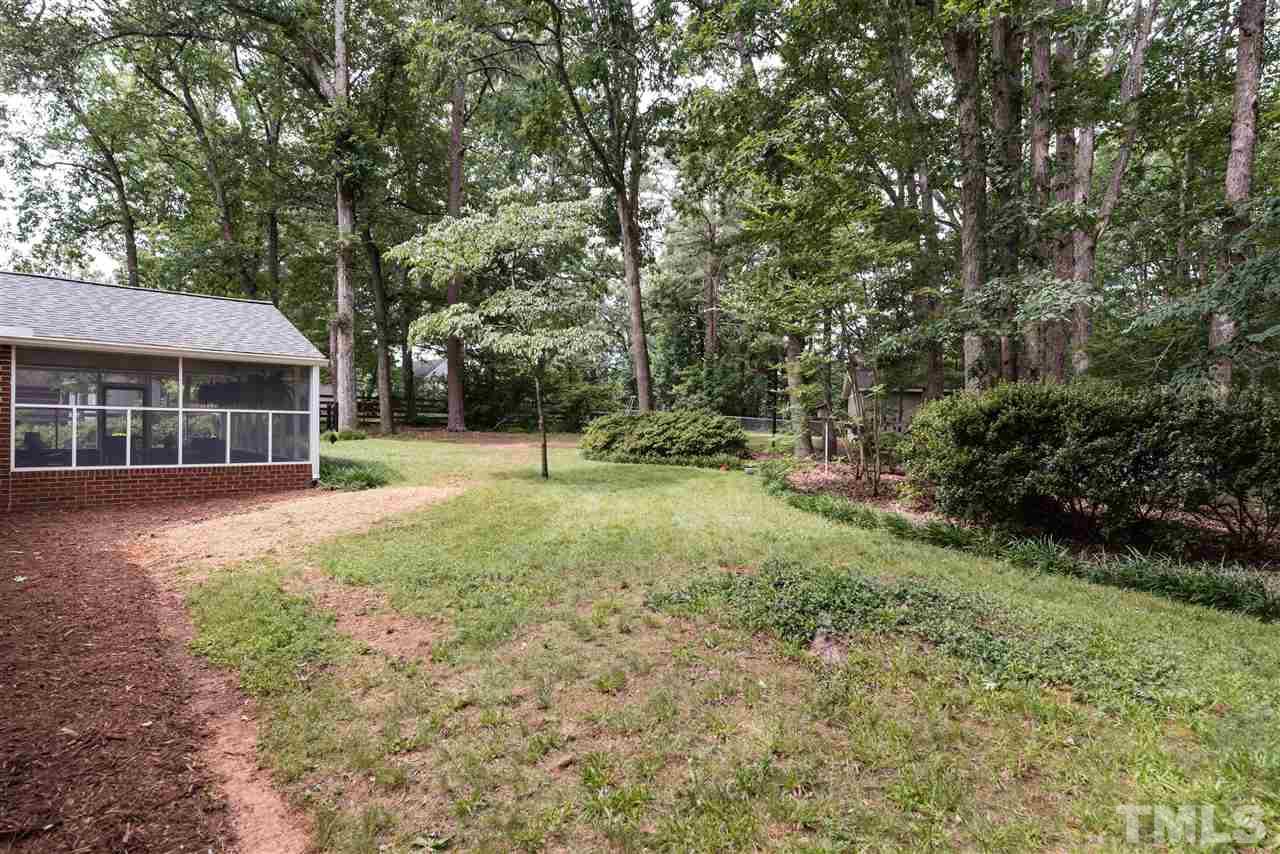 6405 Johnsdale Road Raleigh, NC 27615 - Photo 22 of 25 a view of a house with backyard and trees