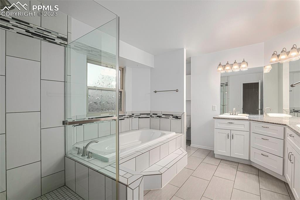 9054 Estebury Circle Colorado Springs, CO 80920 - Photo 13 of 26 a spacious bathroom with a tub sink and mirror