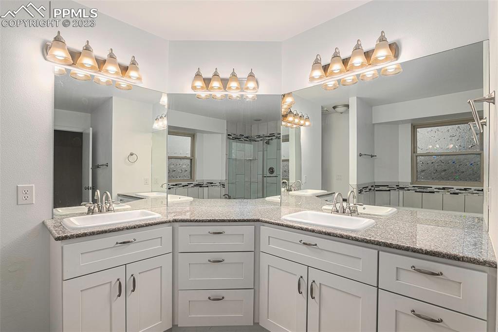 9054 Estebury Circle Colorado Springs, CO 80920 - Photo 14 of 26 a bathroom with a sink double vanity and a mirror