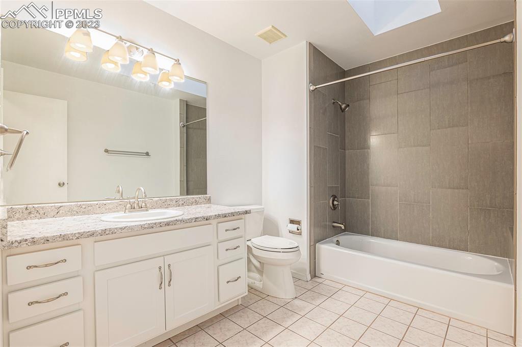9054 Estebury Circle Colorado Springs, CO 80920 - Photo 15 of 26 a bathroom with a granite countertop sink a toilet and shower