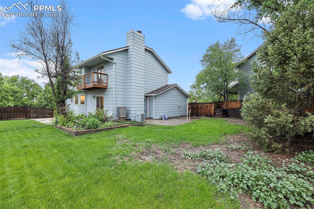 9054 Estebury Circle Colorado Springs, CO 80920 - Photo 22 of 26 a view of a house with backyard and garden