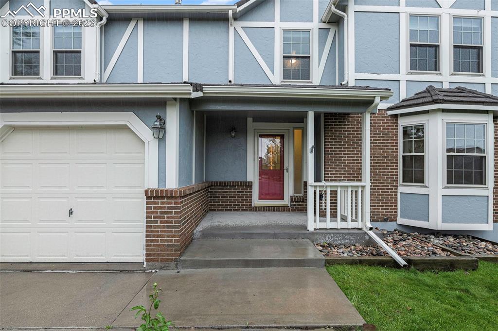 9054 Estebury Circle Colorado Springs, CO 80920 - Photo 3 of 26 a front view of a house with a yard