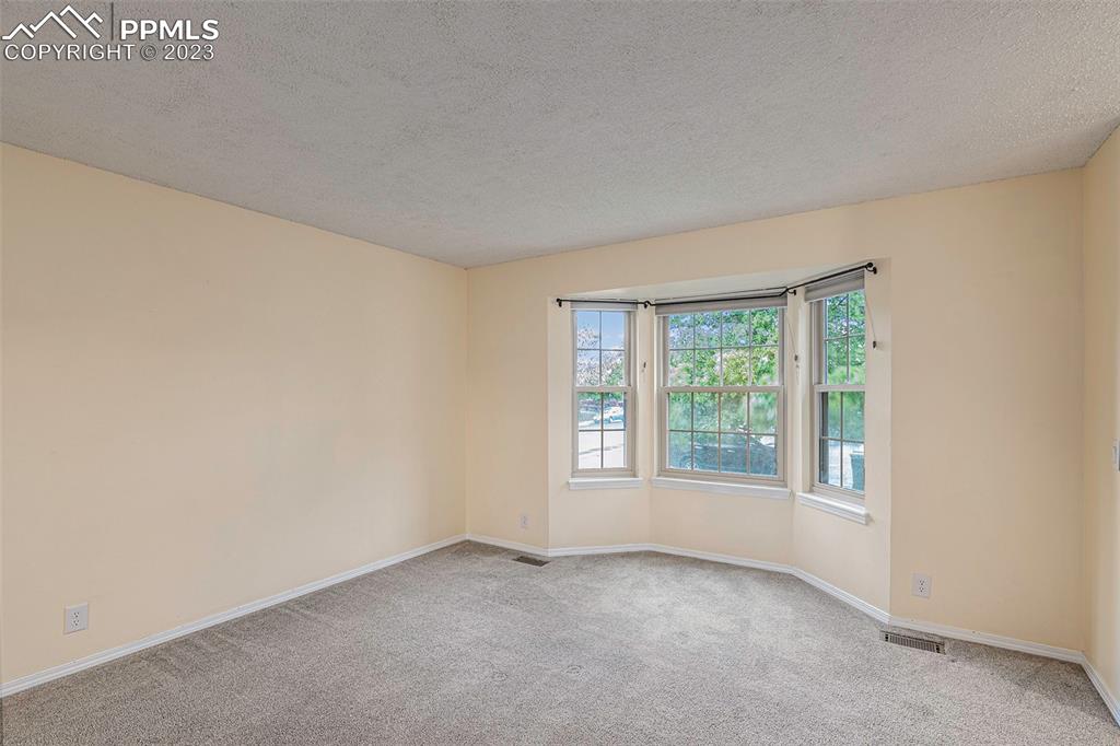 9054 Estebury Circle Colorado Springs, CO 80920 - Photo 4 of 26 an empty room with windows
