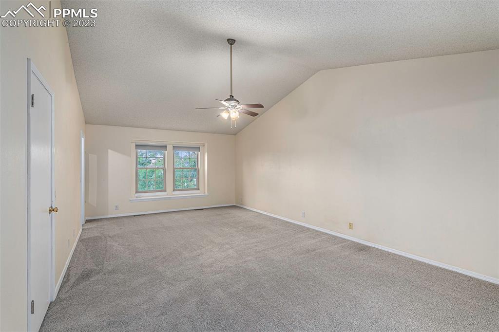 9054 Estebury Circle Colorado Springs, CO 80920 - Photo 8 of 26 an empty room with chandelier fan and windows