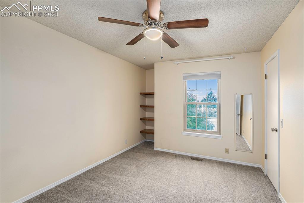 9054 Estebury Circle Colorado Springs, CO 80920 - Photo 10 of 26 an empty room with windows and fan