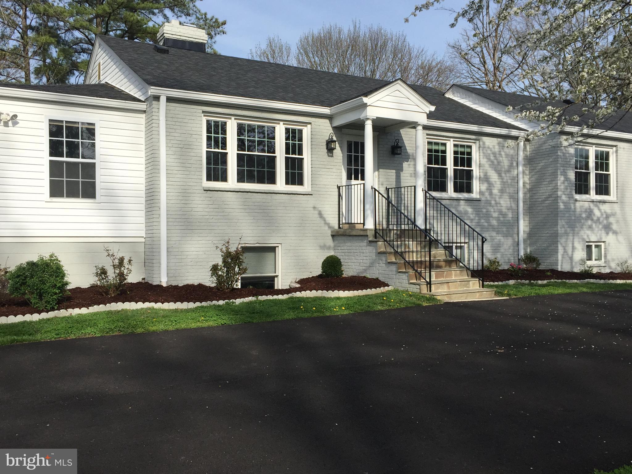 2177 Chain Bridge Road Vienna, VA 22182 - Photo 1 of 48 a front view of a house with a yard