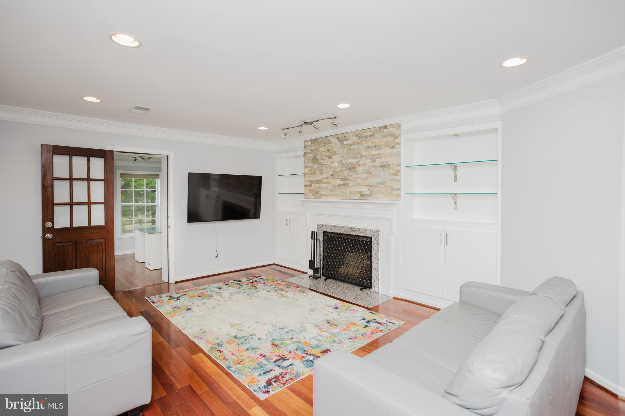 2177 Chain Bridge Road Vienna, VA 22182 - Photo 11 of 48 a living room with furniture and a flat screen tv