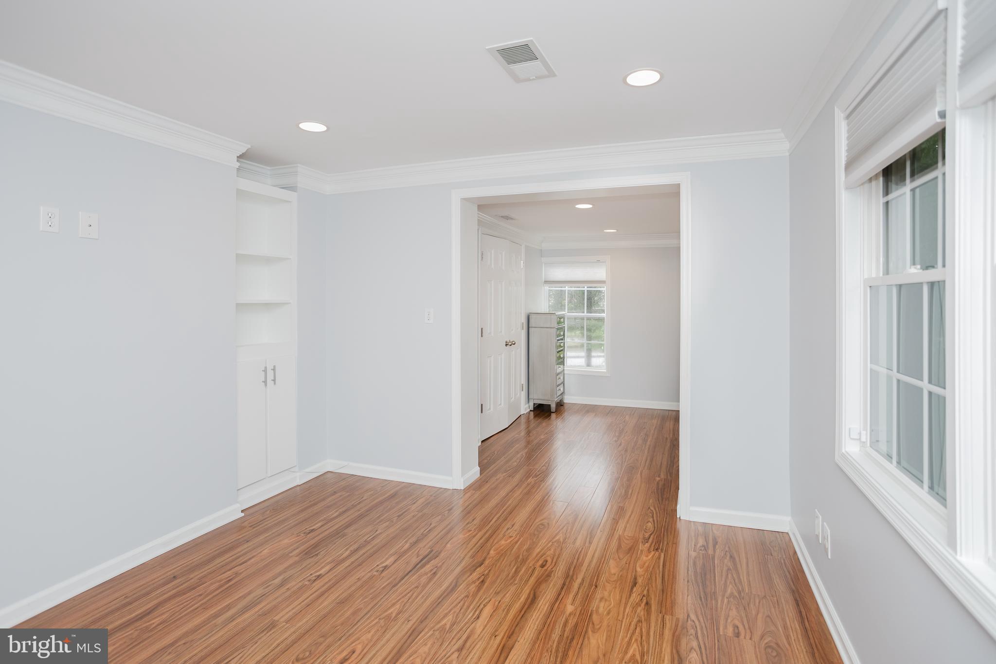 2177 Chain Bridge Road Vienna, VA 22182 - Photo 13 of 48 a view of a room with wooden floor and a window