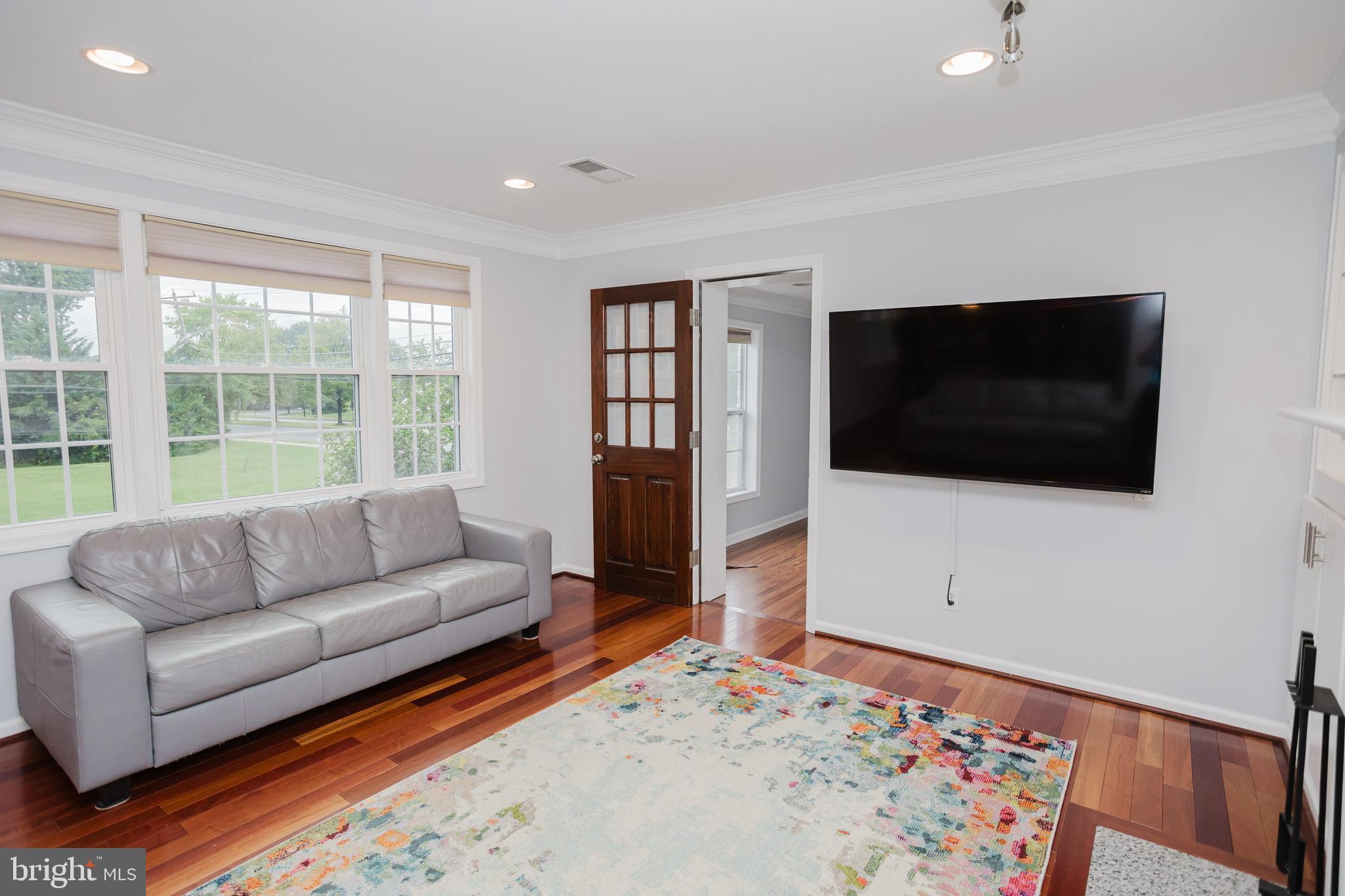 2177 Chain Bridge Road Vienna, VA 22182 - Photo 10 of 48 a living room with a flat screen tv and a couch
