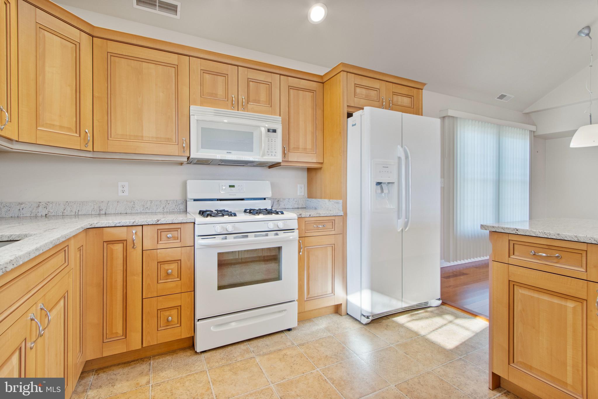 13217 Colonial Road Ocean City, MD 21842 - Photo 8 of 28 Kitchen with Custom Cabinetry & Granite Counters