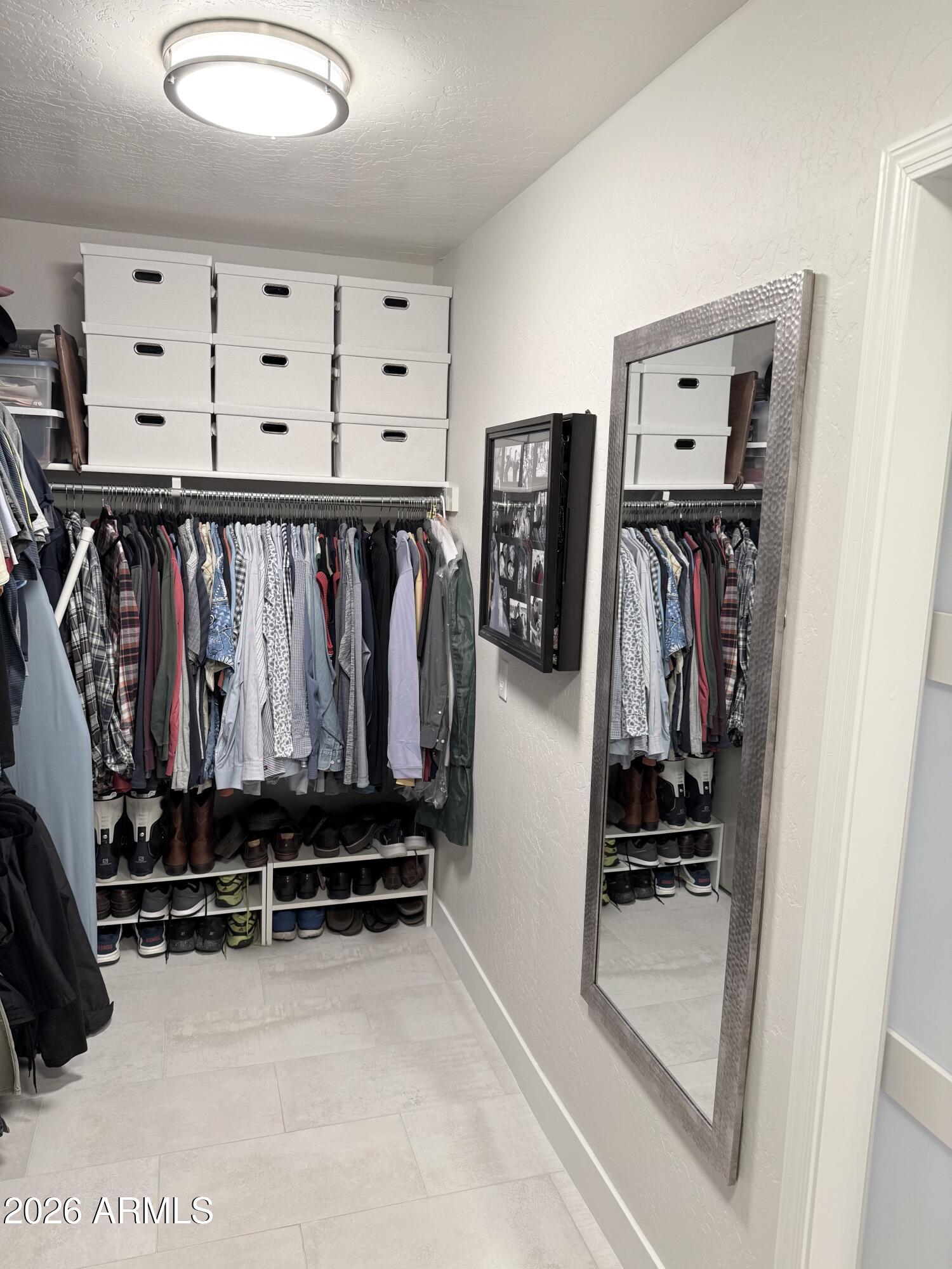 3426 East Clark Road Phoenix, AZ 85050 - Photo 28 of 48 a view of walk in closet with clothes