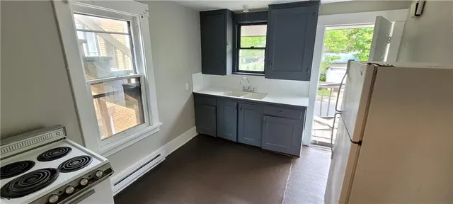 a bathroom with a sink mirror and window