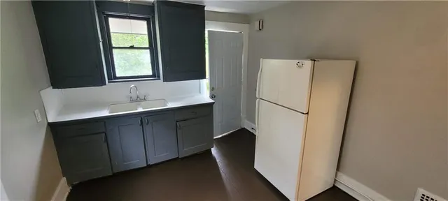 a white refrigerator freezer sitting inside of a kitchen