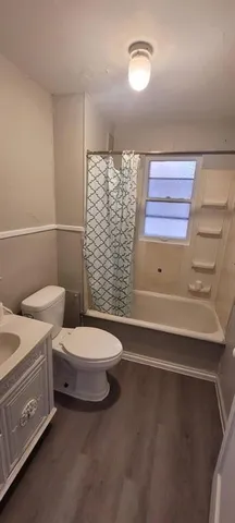 a bathroom with a toilet a sink and bath tub