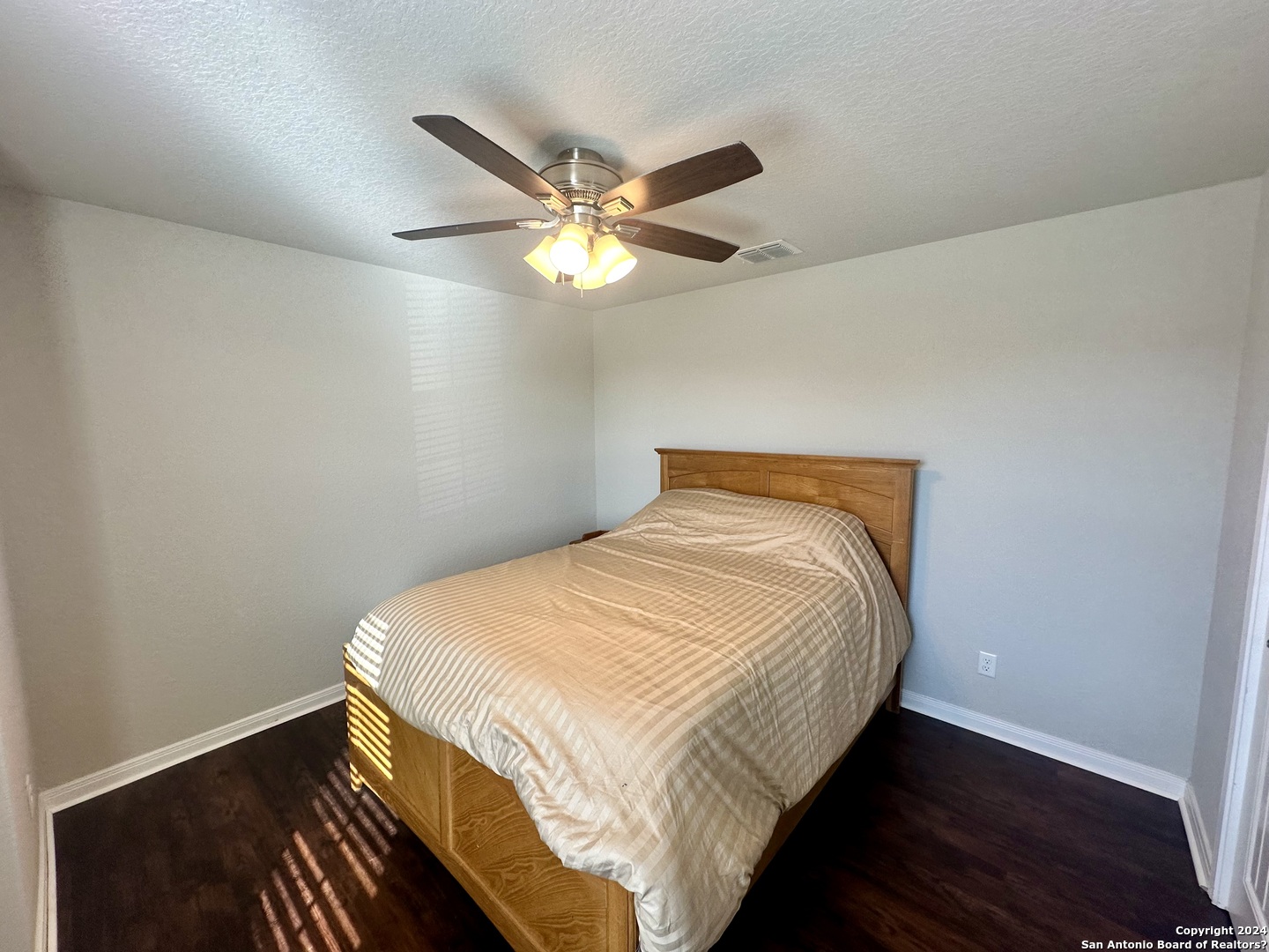 8907 Portobello Converse, TX 78109 - Photo 17 of 26 a bedroom with a bed and a ceiling fan