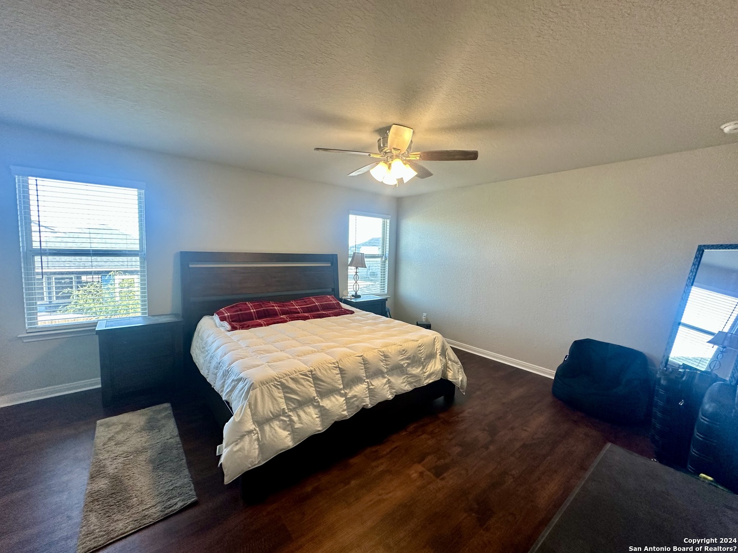 8907 Portobello Converse, TX 78109 - Photo 22 of 26 a bedroom with a bed and window with wooden floor