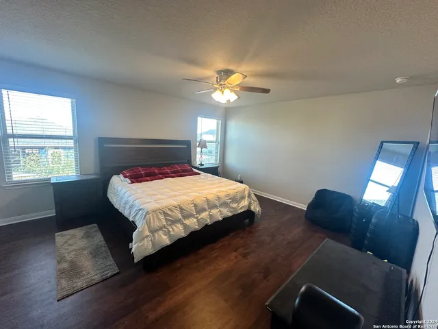 a bedroom with a bed mirror and window