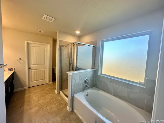 a bathroom with a bathtub and a shower