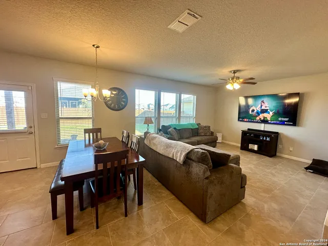 a living room with furniture a rug and a flat screen tv