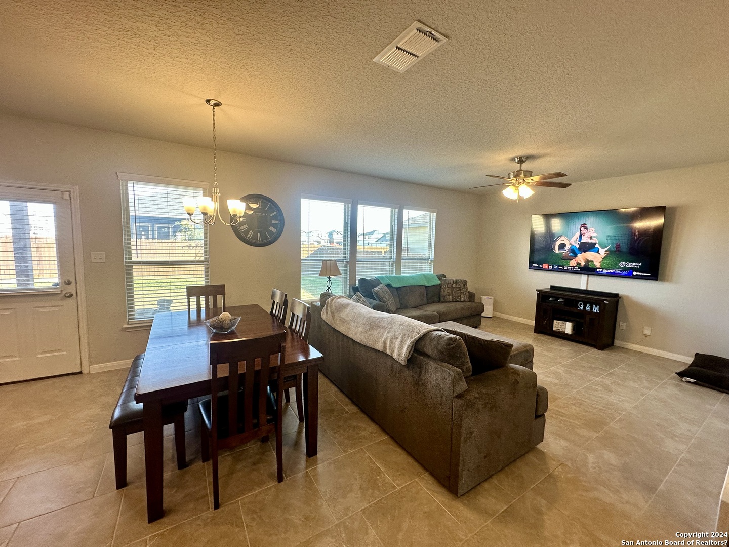8907 Portobello Converse, TX 78109 - Photo 7 of 26 a living room with furniture a rug and a flat screen tv