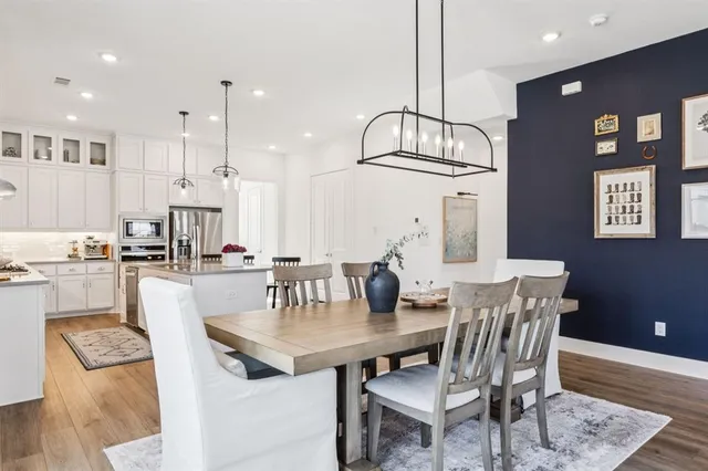 a view of kitchen with dining area refrigerator and wooden floor
