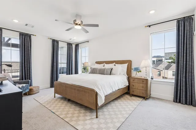 a bedroom with a large bed and a window